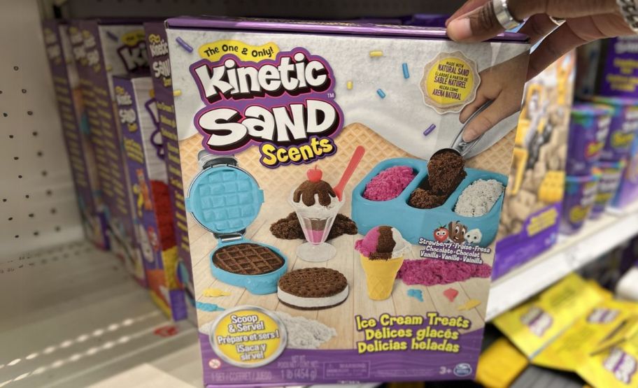 a woman hand holding a kinetic sand ice cream playset