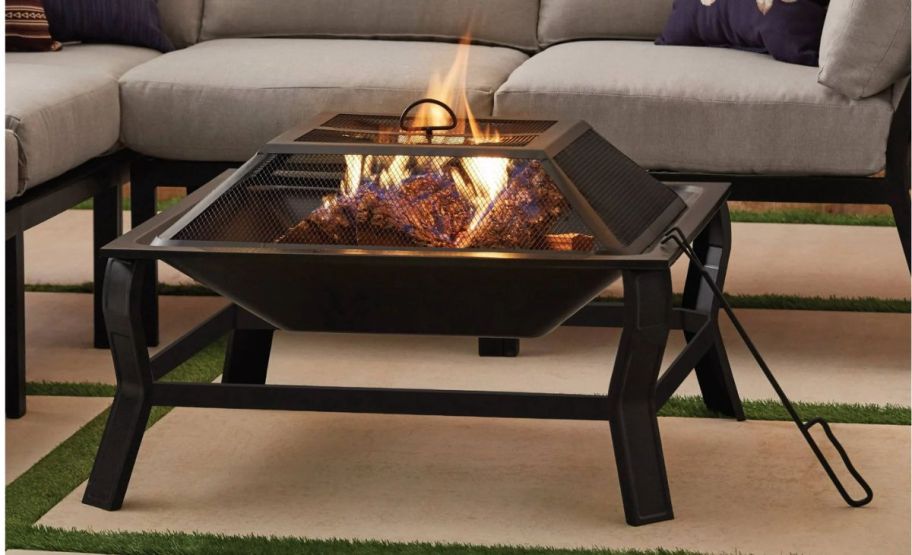 a rectangular fire pit with mesh cover on a patio