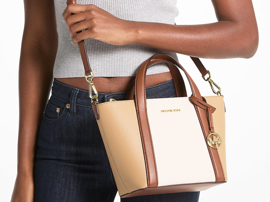 woman with a brown and white tote bag