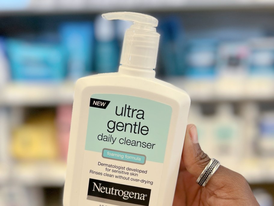 Hand holding bottle of Neutrogena face wash