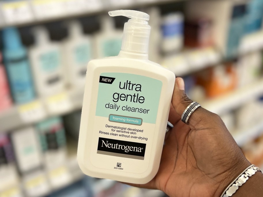 hand holding white bottle of Neutrogena Ultra Gentle Foaming Daily Cleanser