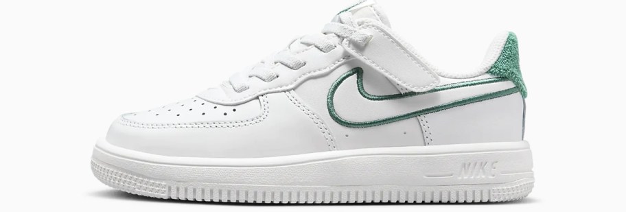 white nike shoe with green stitching