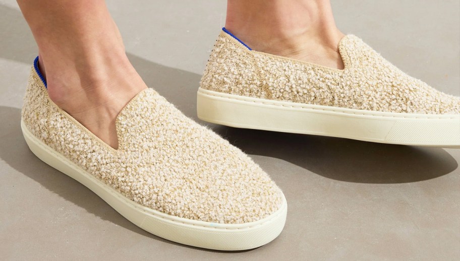 woman wearing fuzzy slip-on sneakers