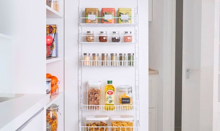 an over the door pantry organizer hanging on a pantry door.