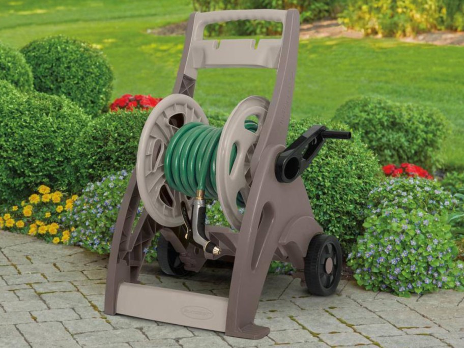plastic hose reel outside on stone patio