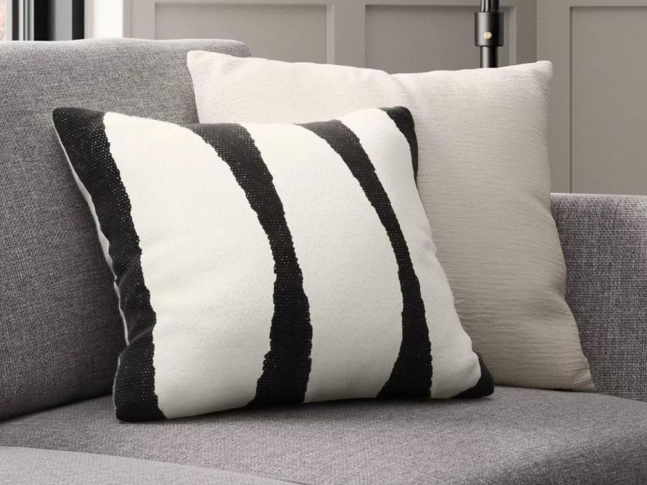 Threshold Cotton Woven Modern Square Throw Pillow in black and white on a couch 