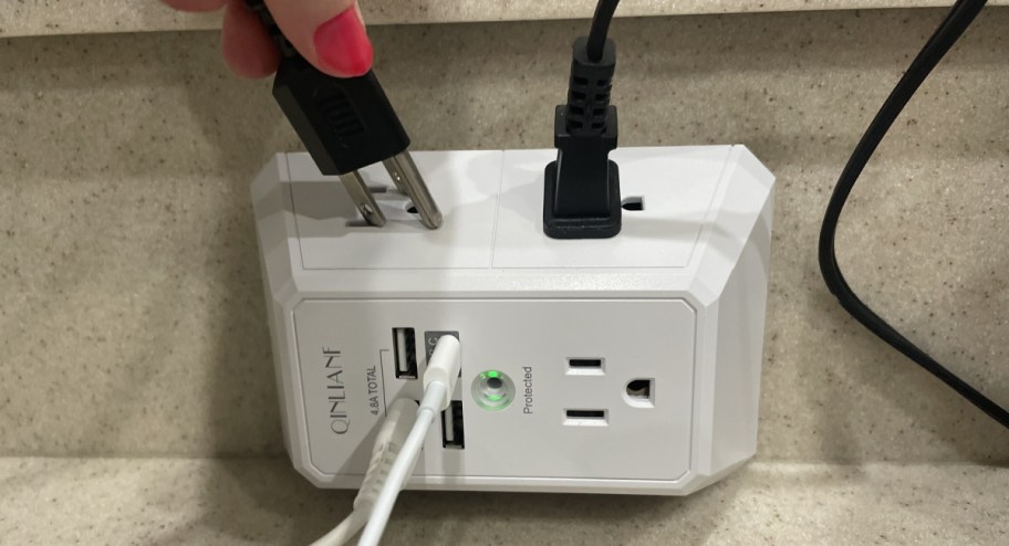 WOman with wall charger that has different extention options