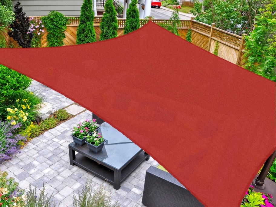 red sun shade covering patio 