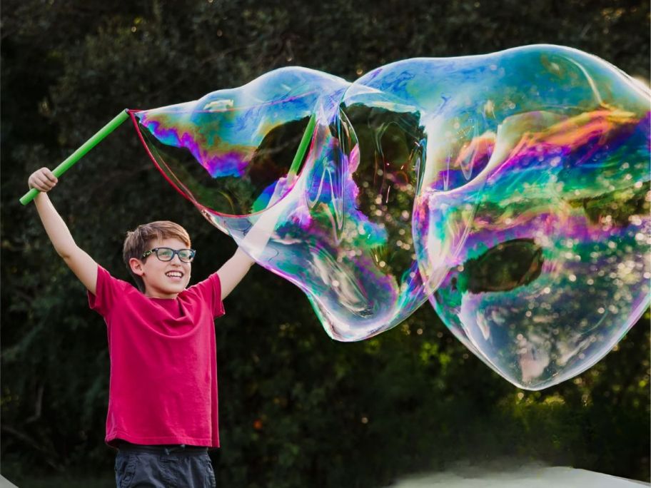 boy making bubbles with the WOWmazing Grab-N-Go onlineplete bubble Kit