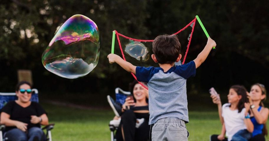 boy making bubbles with the WOWmazing Grab-N-Go onlineplete bubble Kit