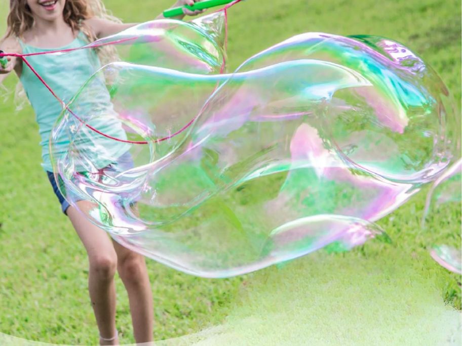 girl making bubbles with the WOWmazing Grab-N-Go onlineplete bubble Kit