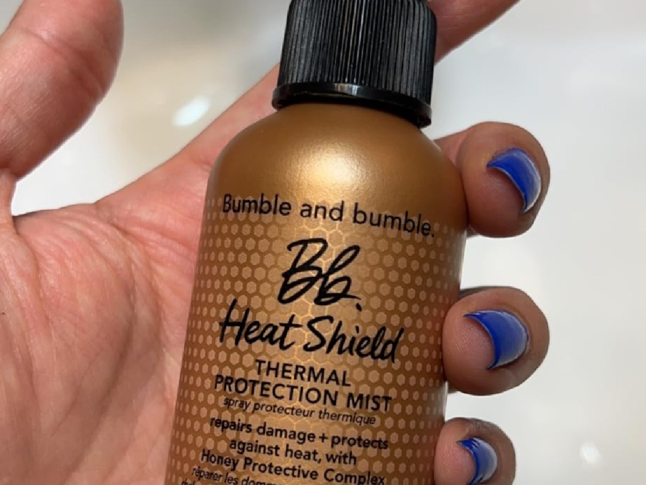 bumble bumble hair shield mist in womans hand