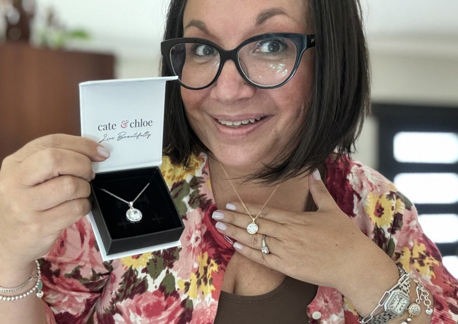 woman holding gift box wearing necklace