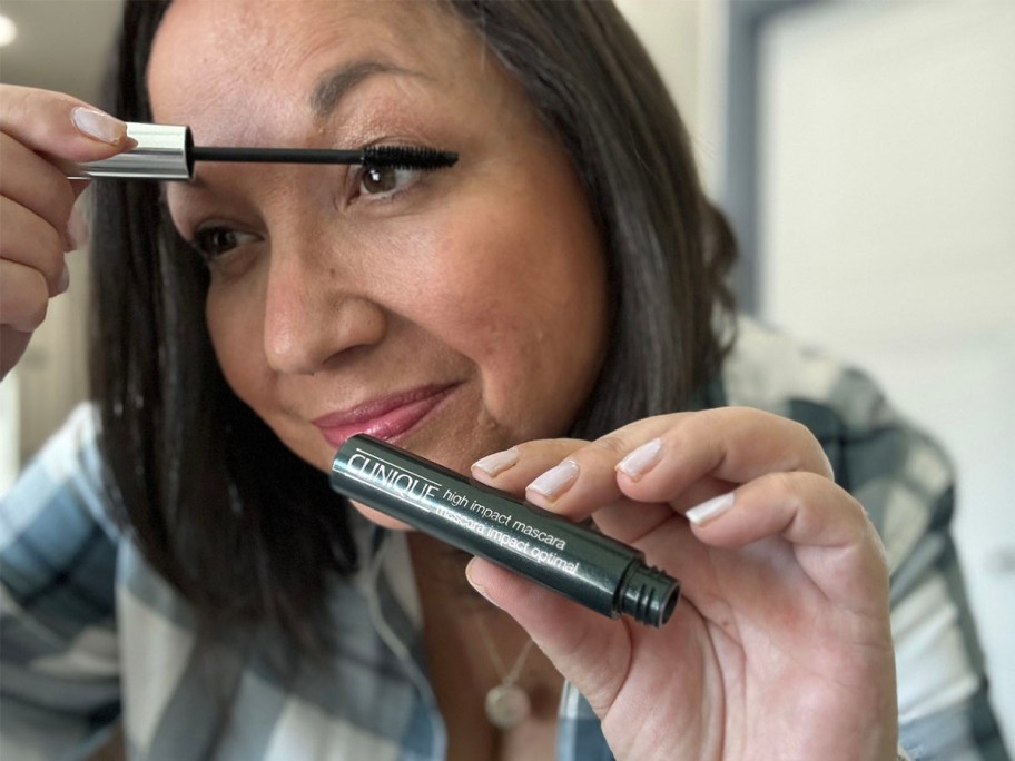 woman putting on clinique high impact mascara