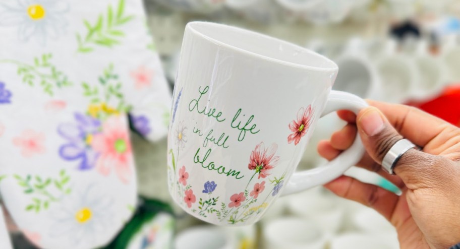 hand holding flower mug