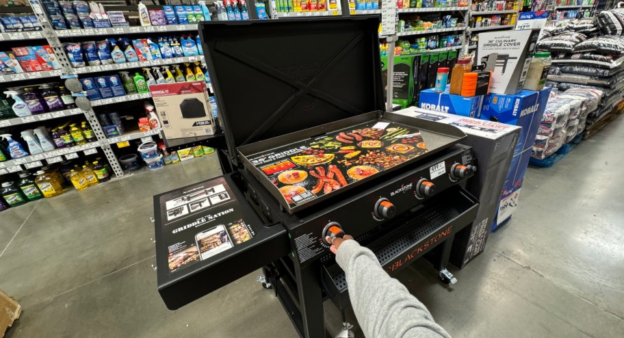 hand touching blackstone omni griddle at the lowes store