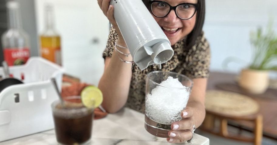 woman using Kitchen HQ Handheld USB Rechargeable Shaved Ice Maker and holding shaved ice in a cup