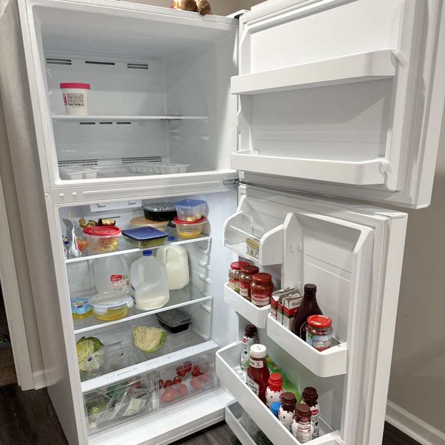 white refrigerator open with food inside 