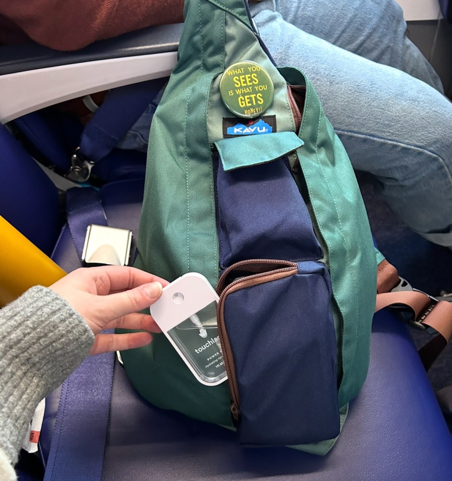 touchland in kavu sling bag on airplane seat