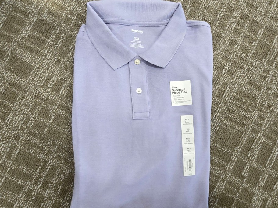 blue sonoma polo shirt laying on carpet