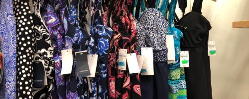 lands end women's swimwear hanging on rack in store