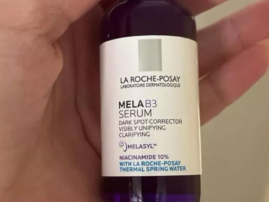 hand holding La Roche Posay Mela B3 Dark Spot Serum bottle