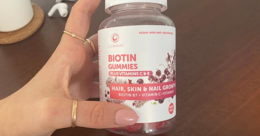 hand holding lunakai biotin gummies bottle