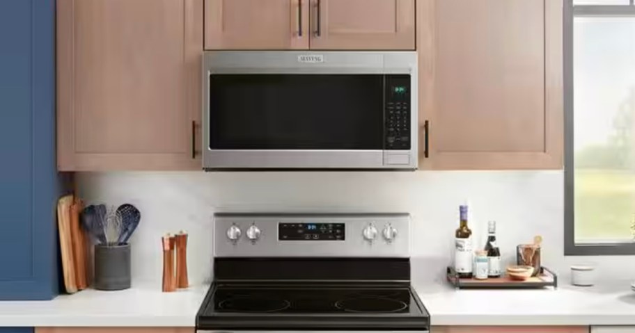 stainless steel and black microwave over oven in kitchen 