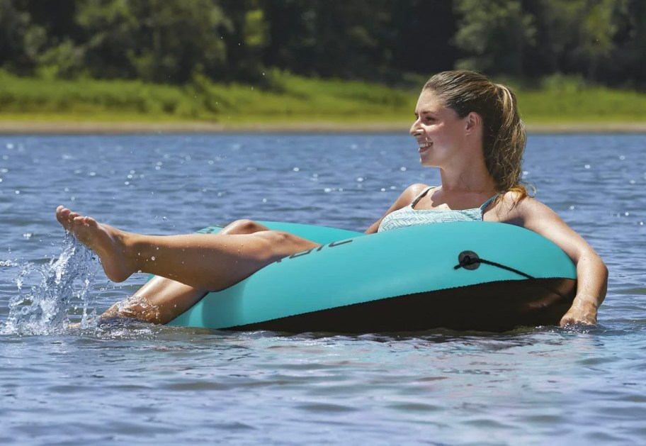 woman in teal float in water