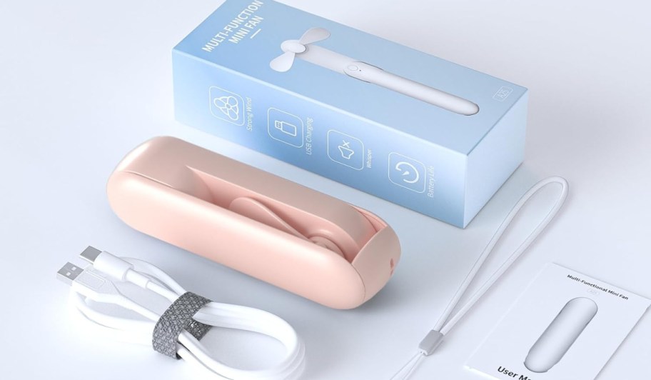 portable mini fan between package and charging cord