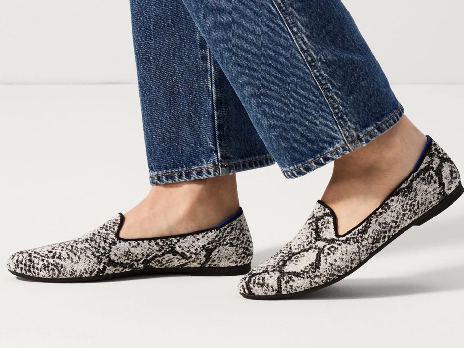 woman wearing gray animal print loafers