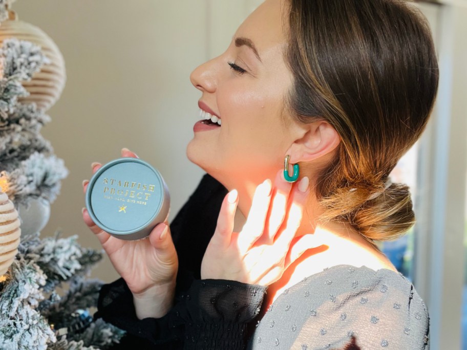 woman wearing turquoise earrings near christmas tree