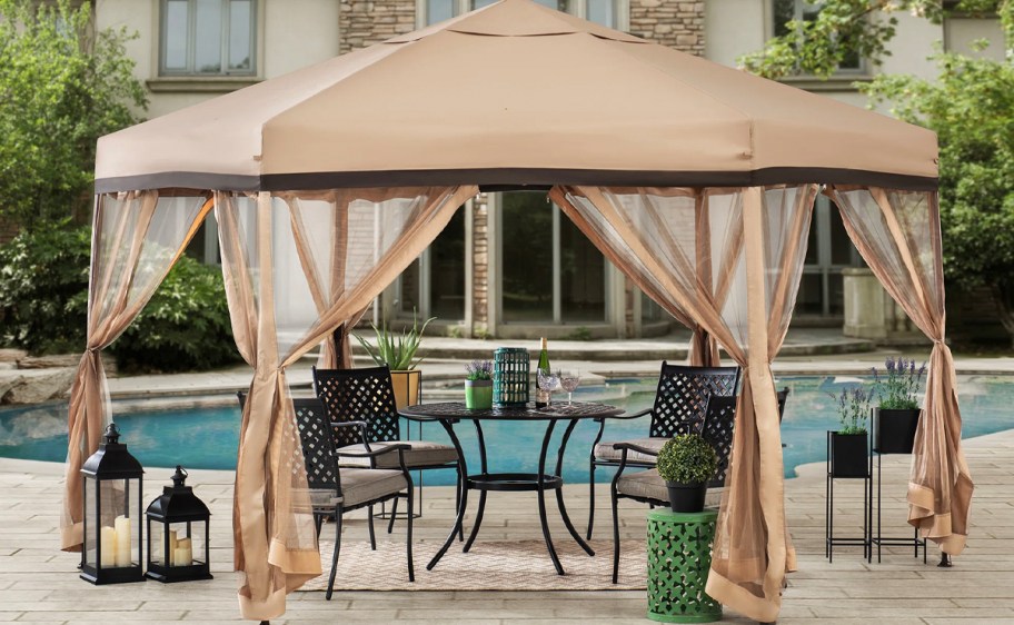 tan pop up gazebo near pool 