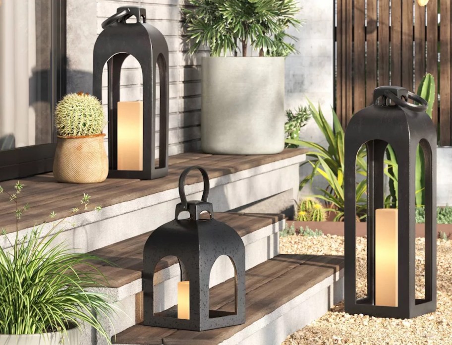 metal lanterns with candles sitting on outdoor steps