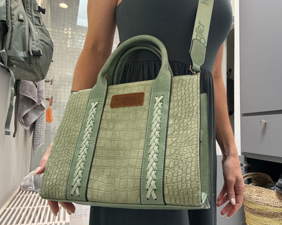 collin wearing sage green tote with strap