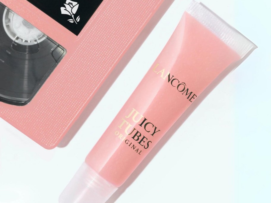 tube of Lancôme Juicy Tubes Original Lip Gloss next to a pink cassette tape