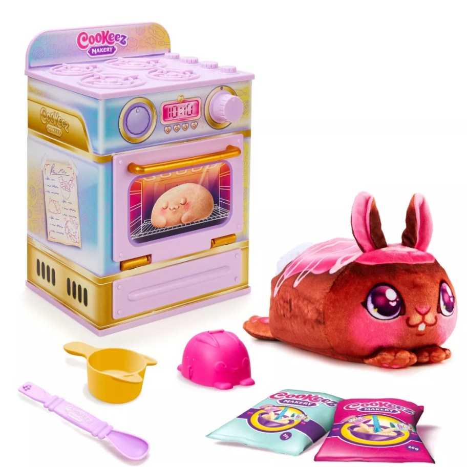 a Cookeez Makery Sweet Treatz Oven Playset with plush and accessories outside the oven box