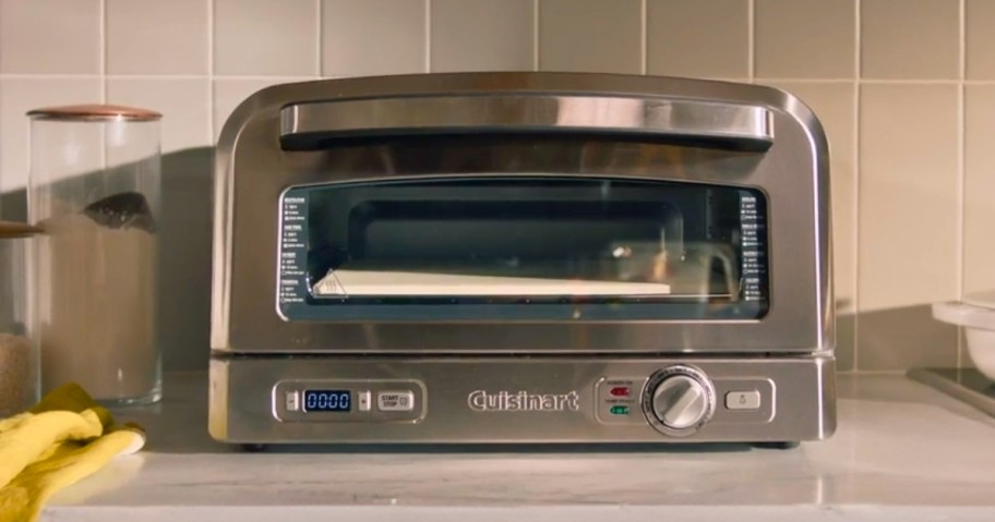 a stainless steel indoor pizza oven sitting on a kitchen counter