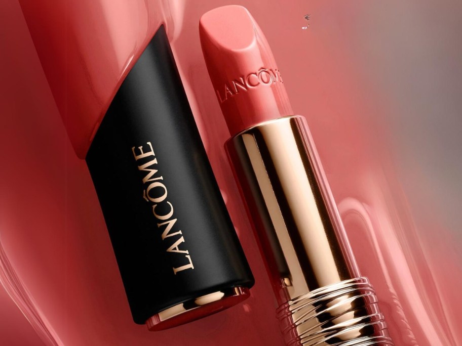 open tube of Lancôme L'Absolu Rouge Cream Lipstick on a pink background 