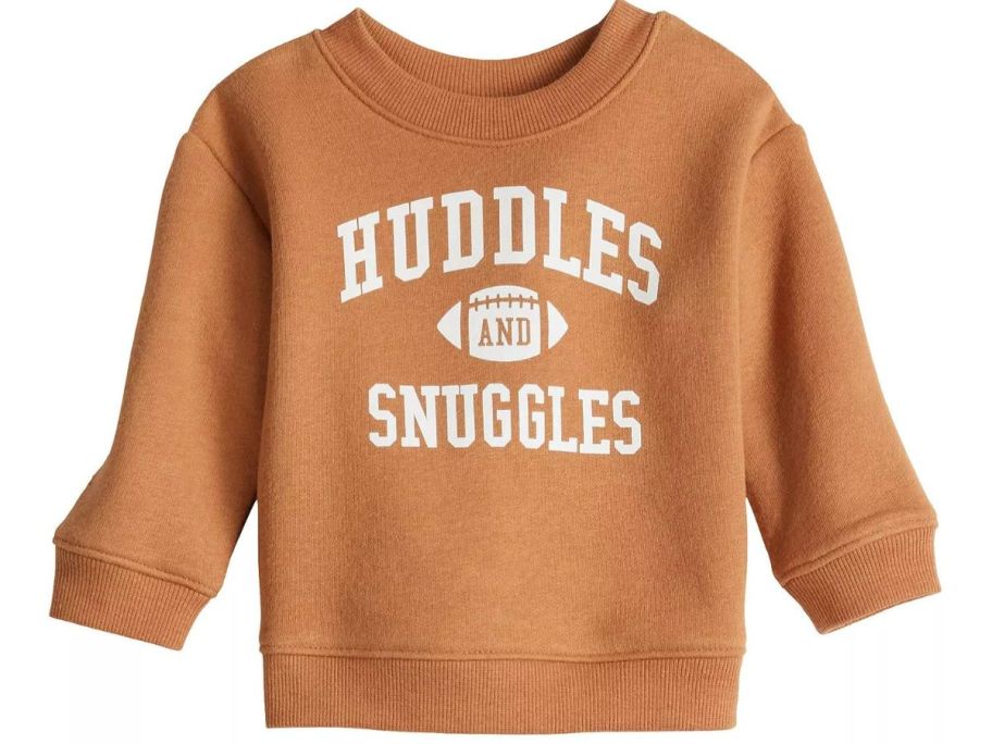 A brown sweatshirt that says "Huddles and Snuggles" 