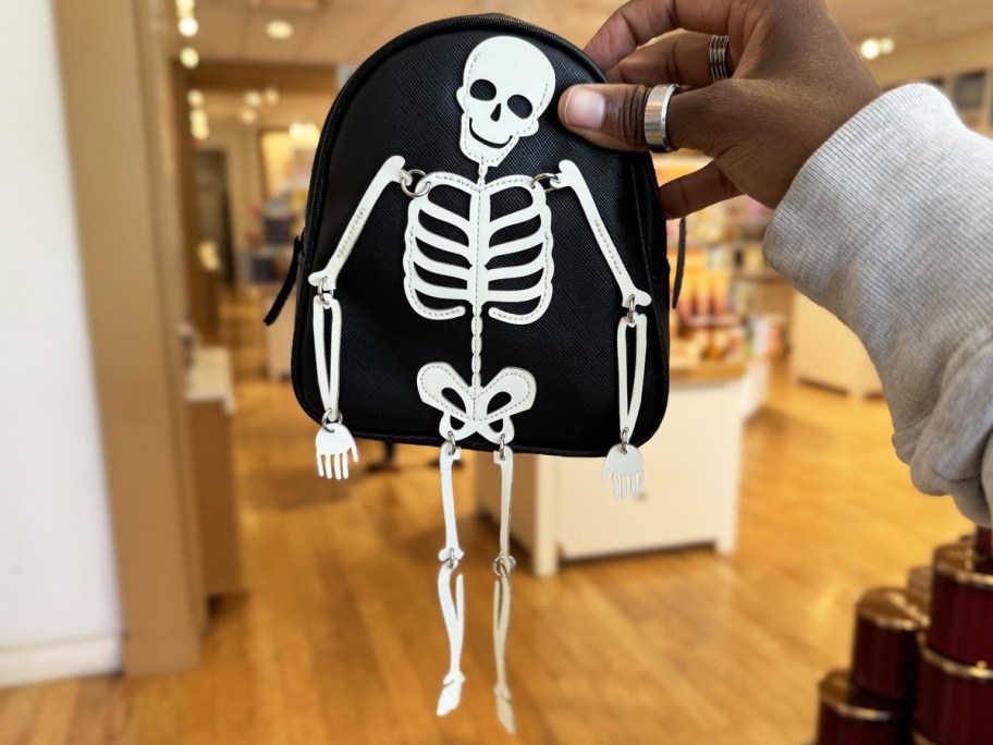 hand holding up Skeleton Backpack Cosmetic Bag