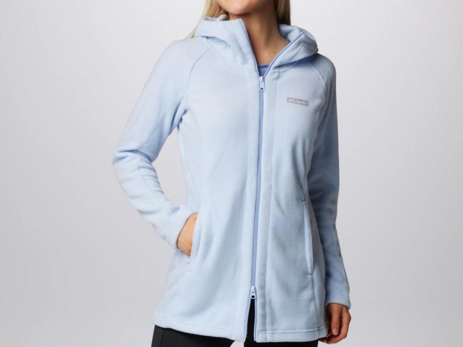 A woman wearing a Columbia Women’s Benton Springs II Long Fleece Hoodie in blue