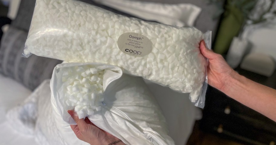 person showing package of coop foam that can be added to pillow