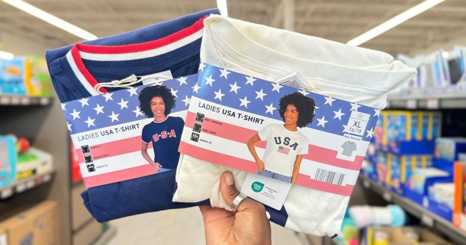 A person holding 2 USA t-shirts