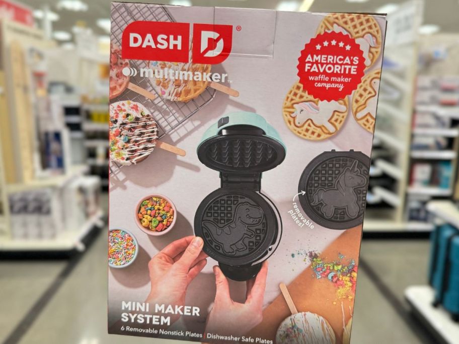 Hand holding up a Dash Multimaker Waffle Maker