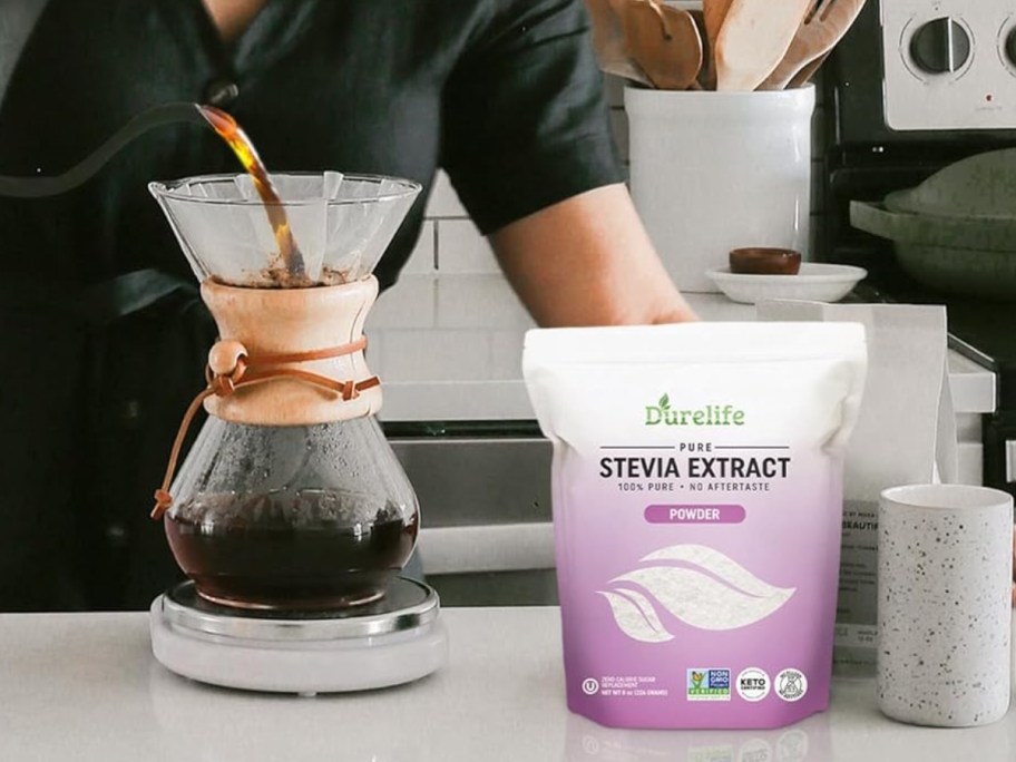 woman pouring coffee into a carafe, bag of Durelife 100% Pure Stevia Extract to the side