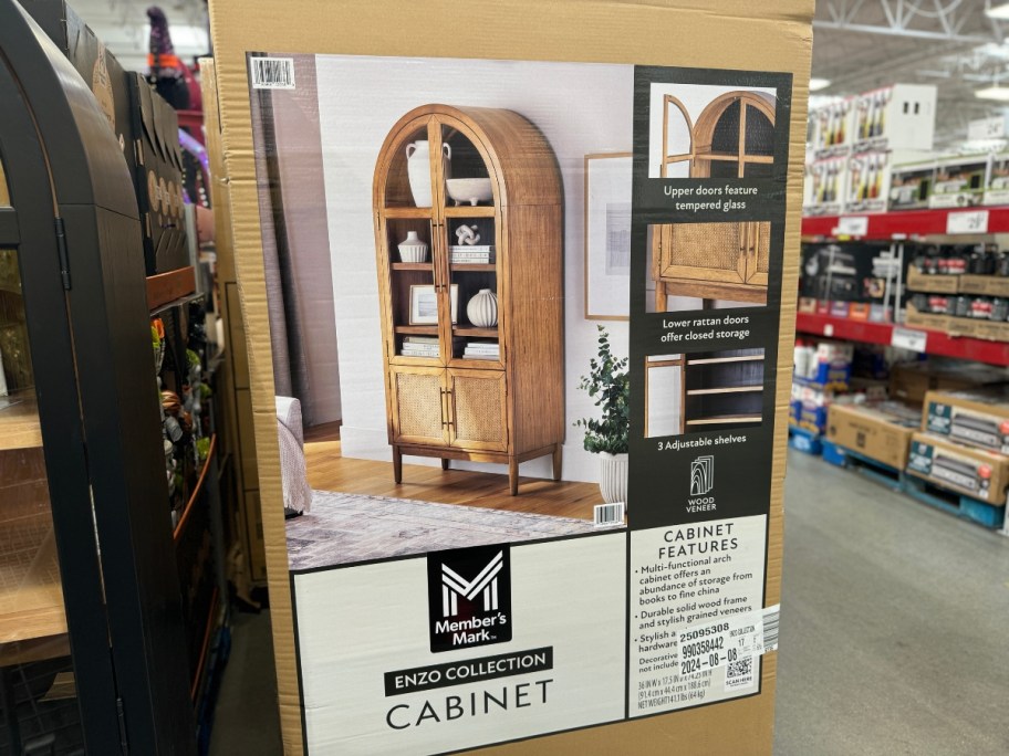 box on store floor with natural colored wood arched cabinet