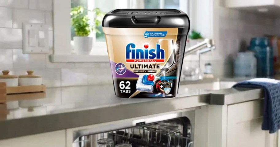 container of Finish Powerball Ultimate Plus Infinity Shine Detergent Tablets on kitchen counter above dishwasher