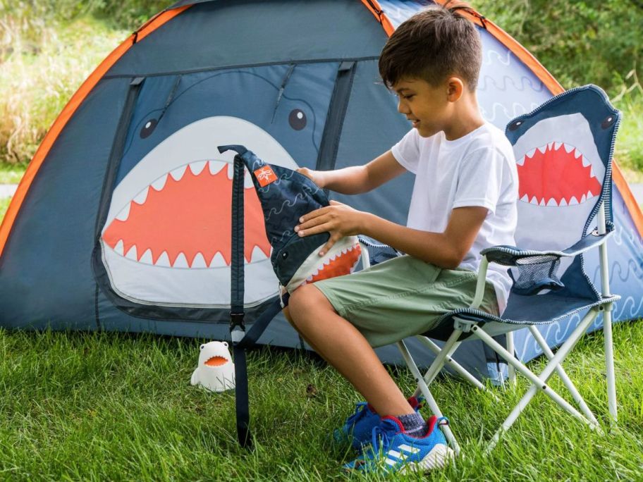 Child sitting in a shark amping chair