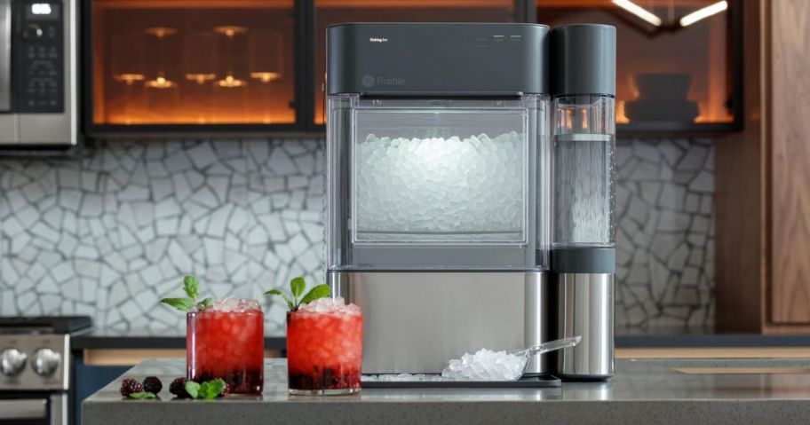 GE Profile Nugget Ice maker 2.0 on a counter next to two drinks